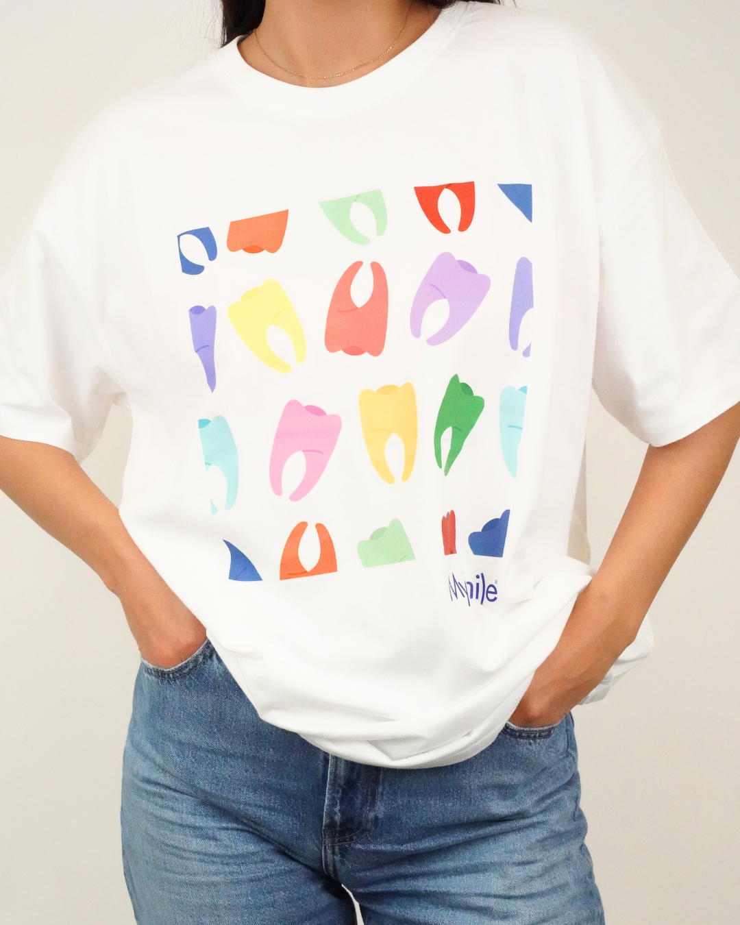 White T-shirt with colorful abstract shapes and the word "Nipple" at the bottom
